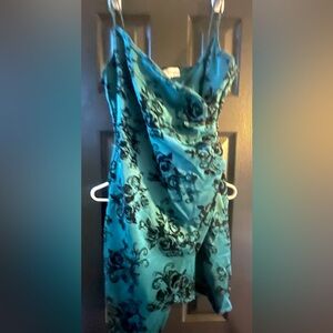 Green dress with black flower decor. Size large.